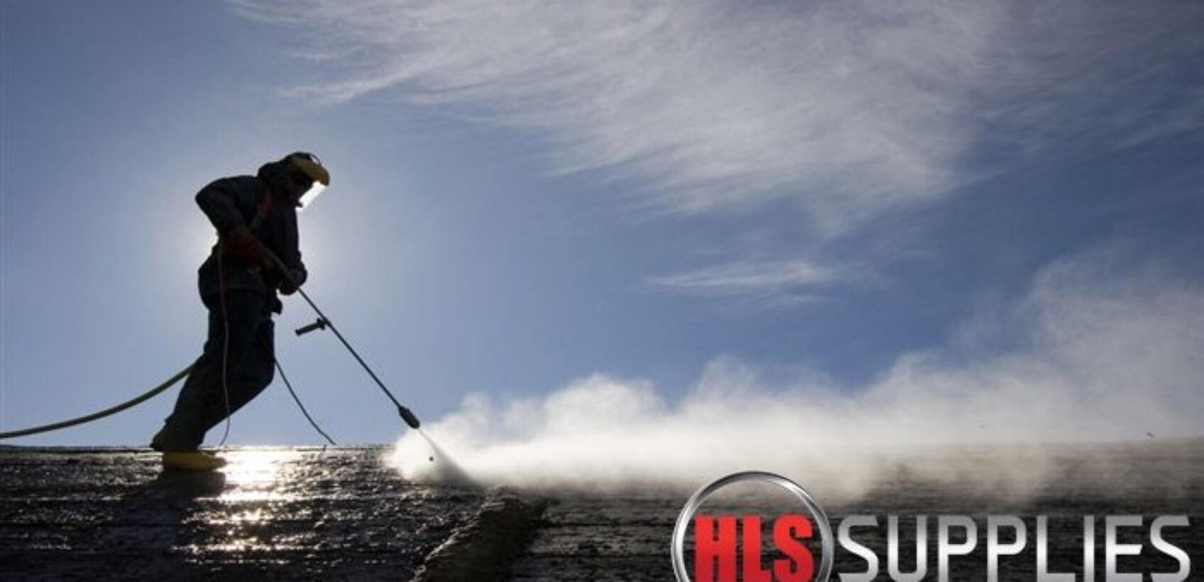 Man with power washer on building HLS Supplies cloud based VoIP