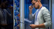 Engineer inspecting an open server rack