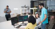 Tech team analysing data on computer screens