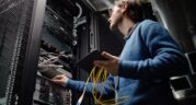 Engineer fixing a server in a rack