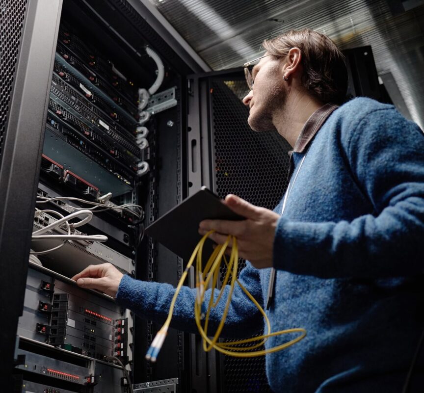 Engineer fixing a server in a rack