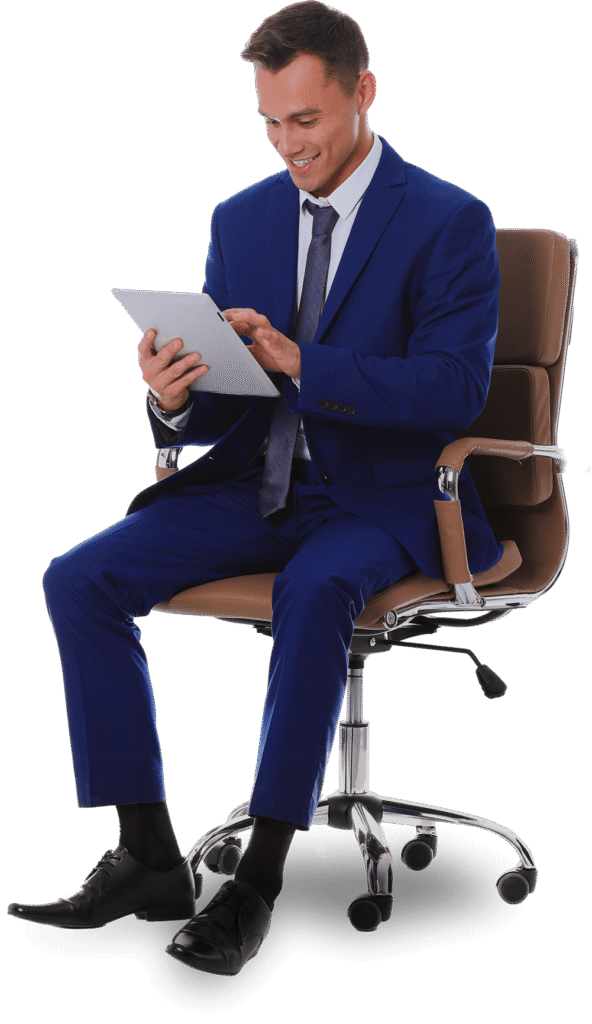 Man in a suit sitting on an office chair looking at a tablet
