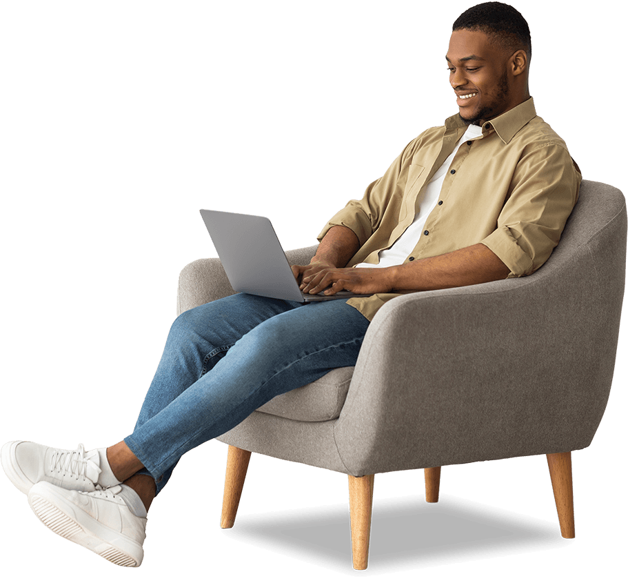 Man sitting on a chair using a laptop
